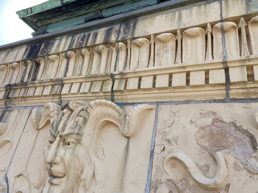 Damaged terracotta grotesque on library chimney